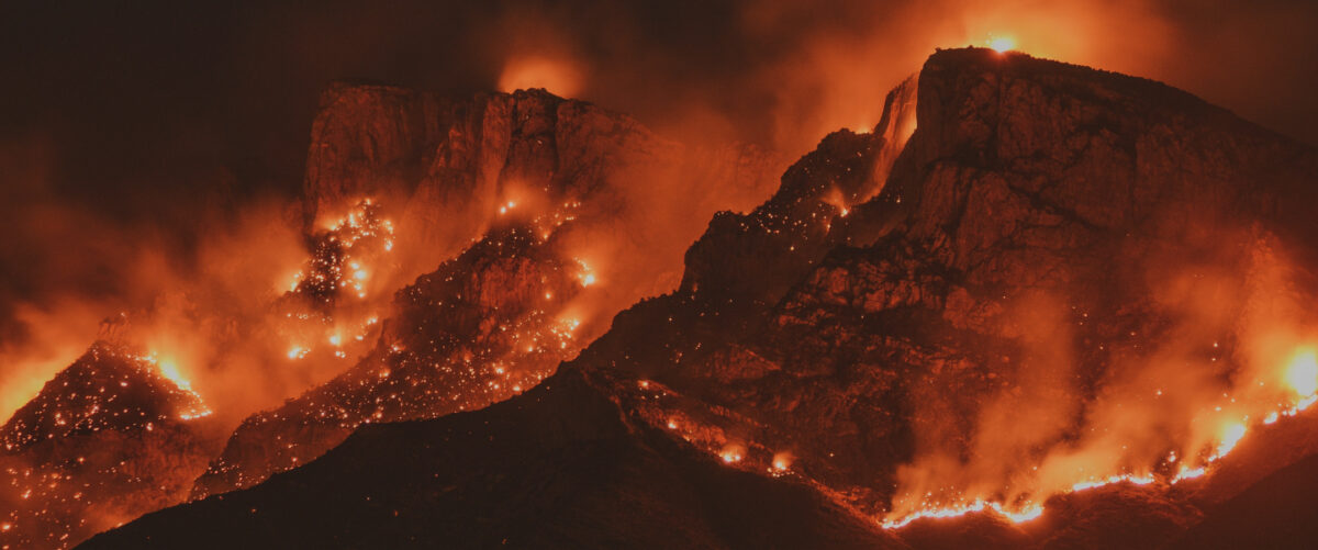 Red fires roar across blackened mountains.